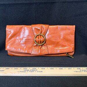 HOBO Intl. Burnt Orange Distressed Leather Bow Fold-over Clutch w/brass accents